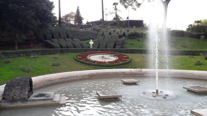 The fountain of Villa Bellini in Catania, and the huge clock just behind it.